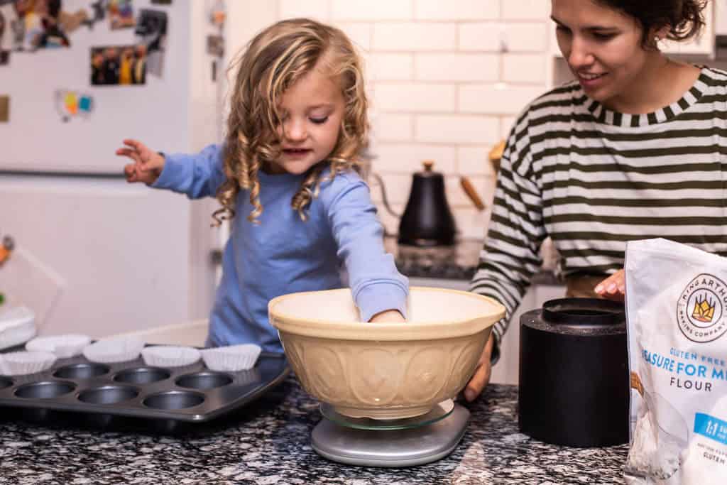 toddler helping in the kitchen and learning life skills