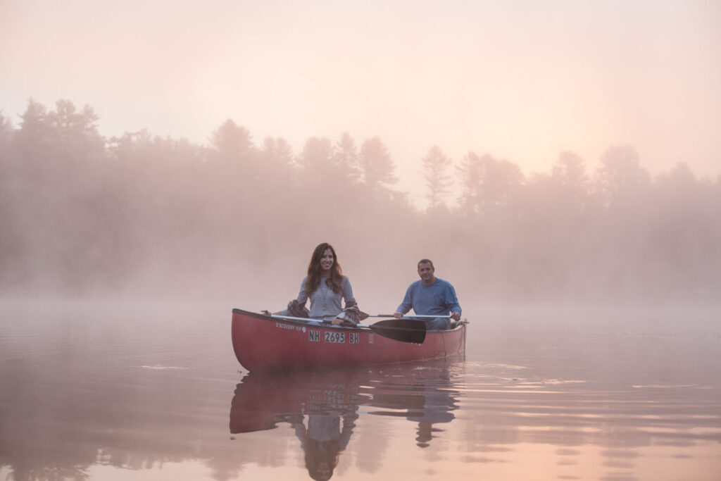 two people in a canoe in the early morning light for a family photo session