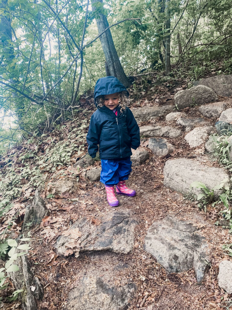 little girl dressed for rainy weather camping